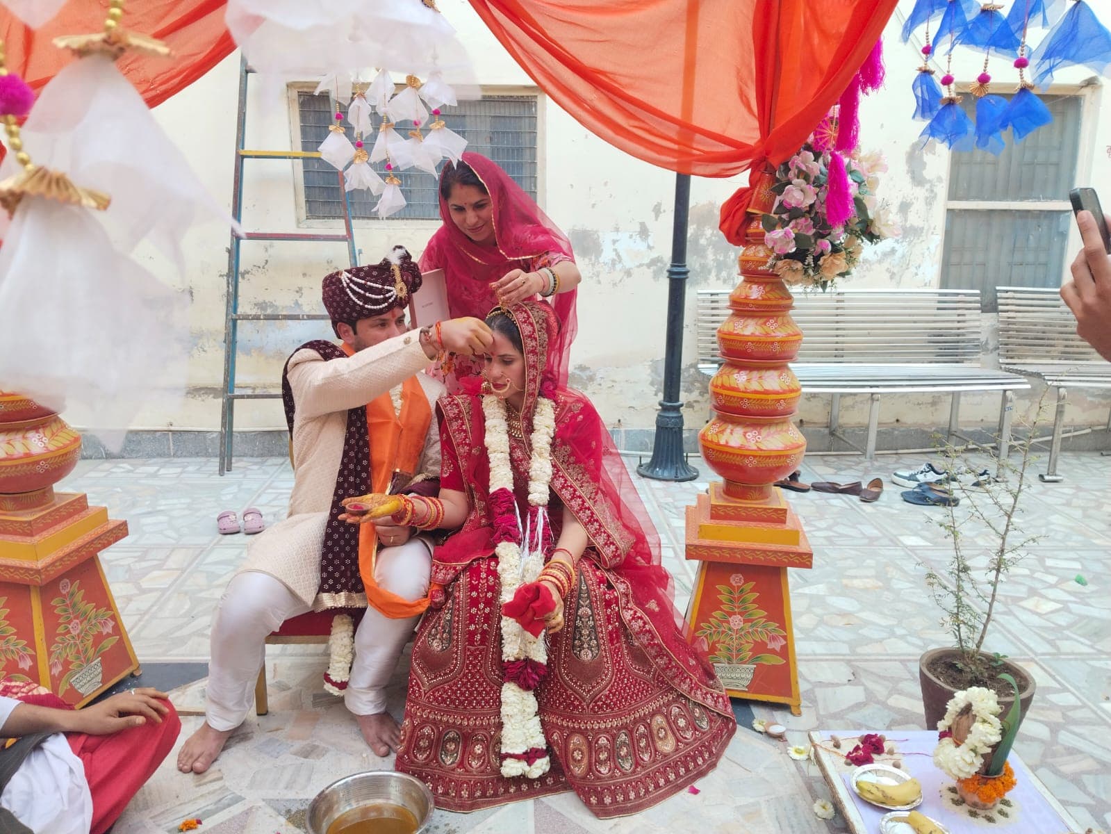 Another couple with marigold garlands